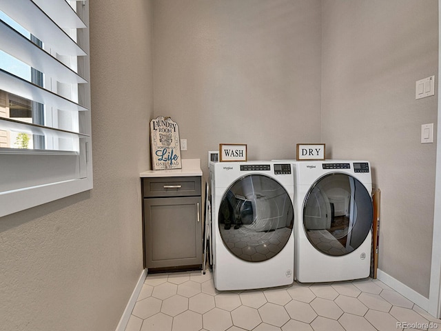 11464 Stonewash St, Littleton, CO 80125 - laundry area featuring cabinet space, baseboards, washer and dryer, and light tile patterned floors