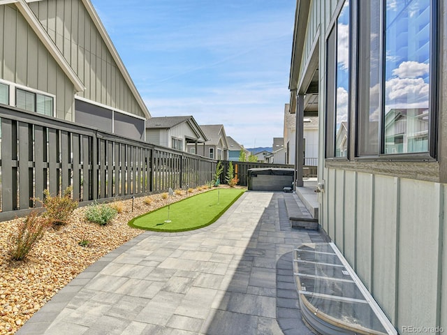 11464 Stonewash St, Littleton, CO 80125 - view of patio with a putting green, a fenced backyard, and a residential view