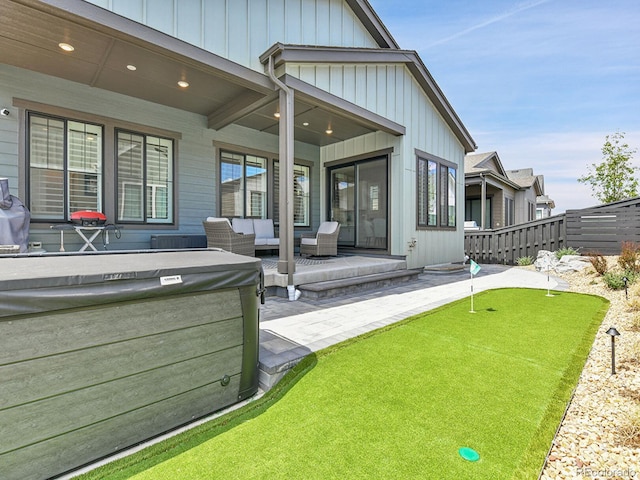 11464 Stonewash St, Littleton, CO 80125 - back of house with an area to practice putting, a patio area, outdoor lounge area, fence, and board and batten siding