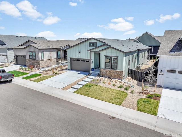 11464 Stonewash St, Littleton, CO 80125 - view of front of property with board and batten siding, stone siding, concrete driveway, a residential view, and an attached garage