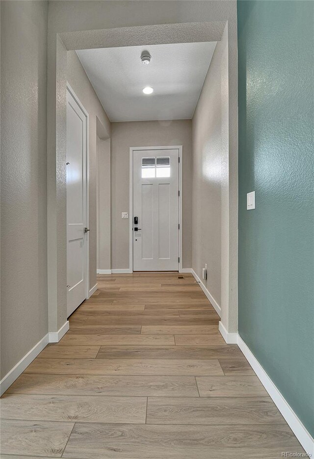 11464 Stonewash St, Littleton, CO 80125 - entryway featuring light wood-type flooring and baseboards