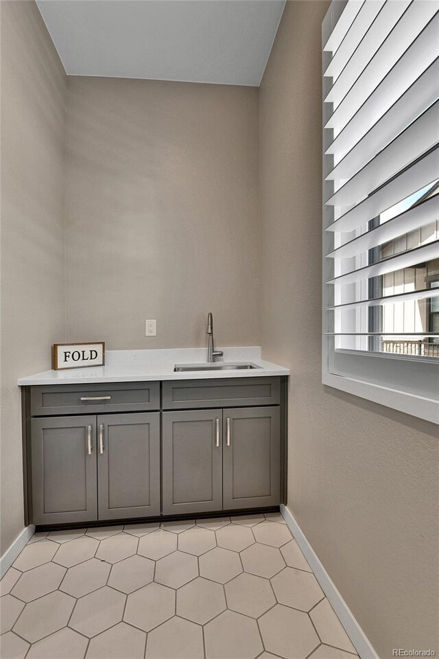 11464 Stonewash St, Littleton, CO 80125 - bathroom featuring a sink and baseboards
