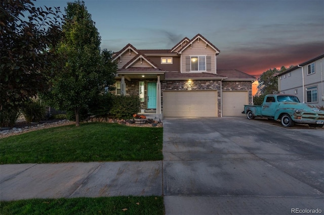 craftsman-style house with a garage and a lawn