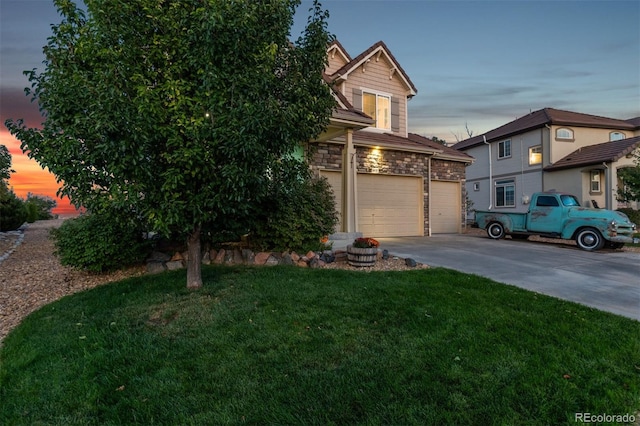 obstructed view of property featuring a garage and a lawn