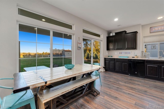 dining space with a healthy amount of sunlight, dark hardwood / wood-style floors, and sink