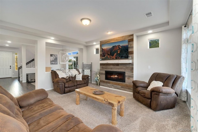 living room with a raised ceiling and a wealth of natural light