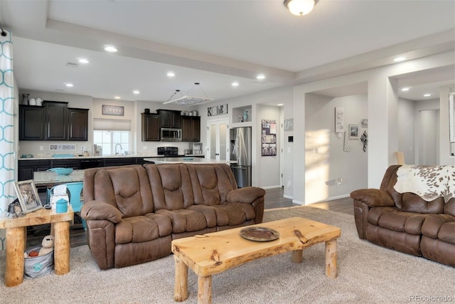 living room featuring light hardwood / wood-style floors and sink