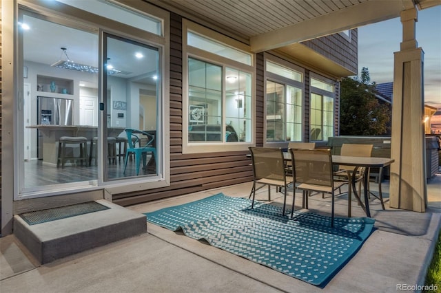 view of patio terrace at dusk