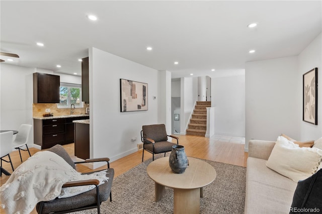 9123 W Arbor Ave, Littleton, CO 80123 - living room with light wood-style floors, recessed lighting, and stairway