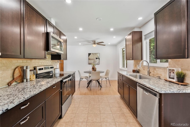 9123 W Arbor Ave, Littleton, CO 80123 - kitchen with stainless steel appliances, ceiling fan, recessed lighting, and dark brown cabinets