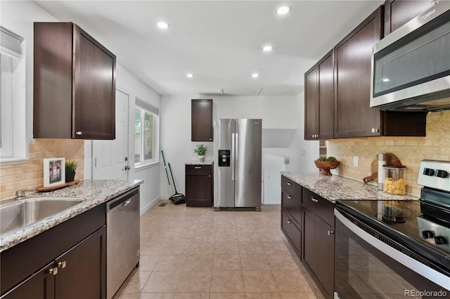 9123 W Arbor Ave, Littleton, CO 80123 - kitchen with appliances with stainless steel finishes, dark brown cabinets, backsplash, and recessed lighting