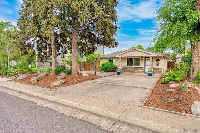 404 S Jasmine St, Denver, CO 80224 - view of front of house featuring driveway, a porch, stone siding, and stucco siding