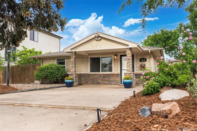 404 S Jasmine St, Denver, CO 80224 - view of front of property featuring stucco siding, stone siding, and covered porch
