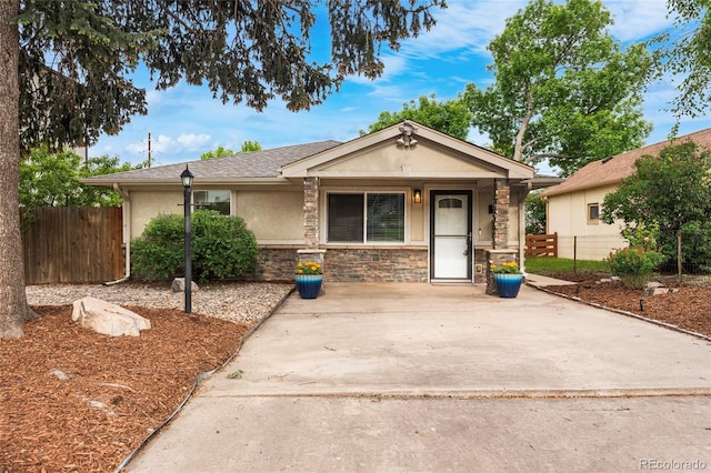 404 S Jasmine St, Denver, CO 80224 - view of front of home with stucco siding, stone siding, and a porch