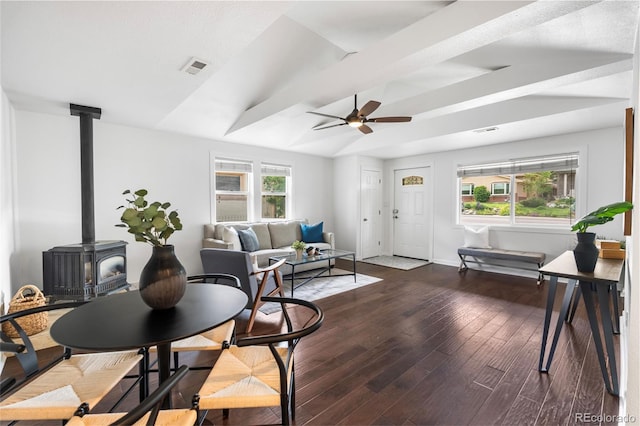 404 S Jasmine St, Denver, CO 80224 - living area with a wood stove, a ceiling fan, wood finished floors, baseboards, and vaulted ceiling