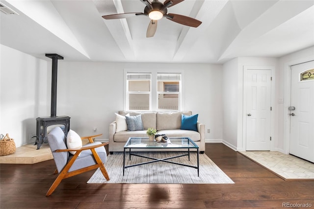 404 S Jasmine St, Denver, CO 80224 - living area with hardwood / wood-style floors, a wood stove, ceiling fan, and baseboards
