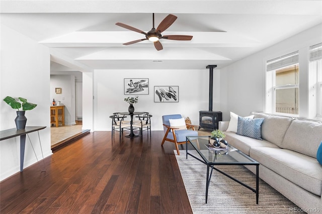 404 S Jasmine St, Denver, CO 80224 - living area with a wood stove, dark wood finished floors, a ceiling fan, beam ceiling, and baseboards