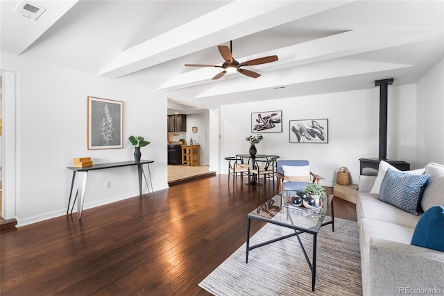 404 S Jasmine St, Denver, CO 80224 - living area featuring ceiling fan, wood finished floors, lofted ceiling, a wood stove, and baseboards