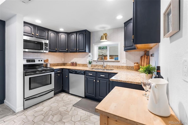 404 S Jasmine St, Denver, CO 80224 - kitchen featuring stainless steel appliances, a sink, decorative backsplash, recessed lighting, and light stone counters