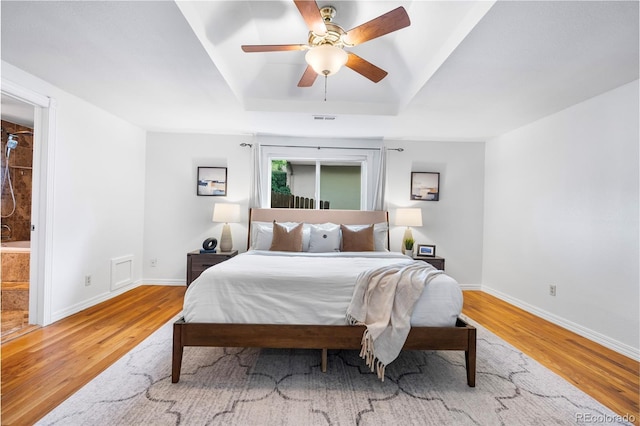 404 S Jasmine St, Denver, CO 80224 - bedroom with light wood-style flooring, a raised ceiling, baseboards, and ensuite bath