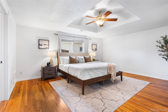 404 S Jasmine St, Denver, CO 80224 - bedroom with a raised ceiling, baseboards, wood-type flooring, and a ceiling fan