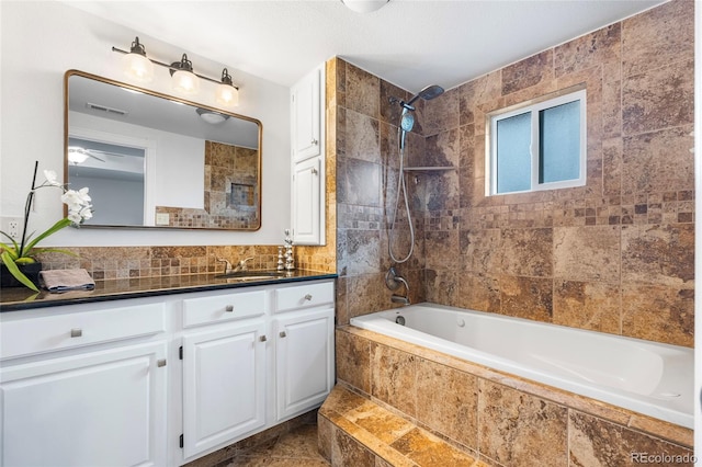 404 S Jasmine St, Denver, CO 80224 - full bath featuring tiled shower / bath combo, vanity, and tile walls