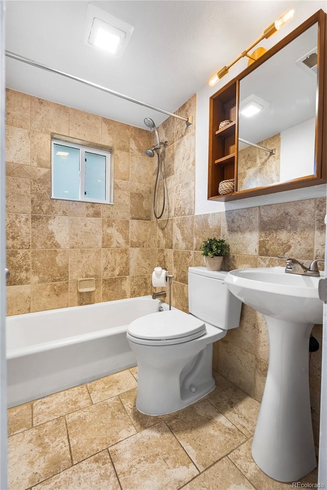 404 S Jasmine St, Denver, CO 80224 - full bathroom featuring tile walls, bathtub / shower combination, toilet, and stone tile flooring