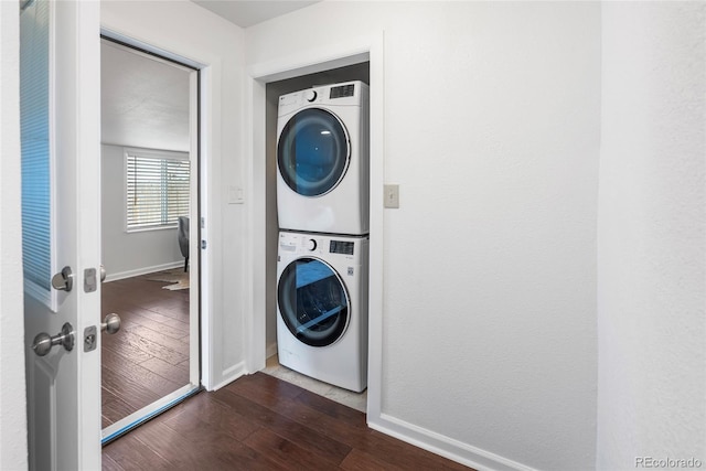 404 S Jasmine St, Denver, CO 80224 - laundry room with stacked washer and clothes dryer, dark wood finished floors, and baseboards