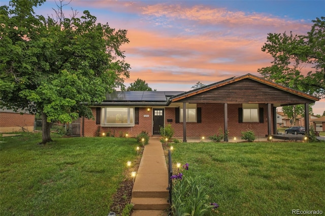 4293 Graham Ct, Boulder, CO 80305 - view of front of house with solar panels, a lawn, and brick siding