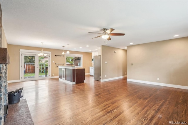 4293 Graham Ct, Boulder, CO 80305 - unfurnished living room with ceiling fan, wood finished floors, recessed lighting, baseboards, and a stone fireplace