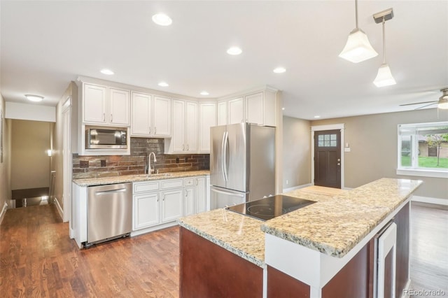 4293 Graham Ct, Boulder, CO 80305 - kitchen with stainless steel appliances, dark wood-style floors, a sink, baseboards, and recessed lighting
