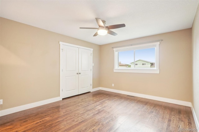 4293 Graham Ct, Boulder, CO 80305 - unfurnished bedroom featuring wood finished floors, baseboards, a closet, and ceiling fan