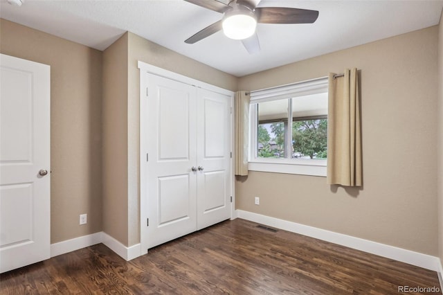 4293 Graham Ct, Boulder, CO 80305 - unfurnished bedroom featuring baseboards, dark wood-style flooring, a closet, and ceiling fan