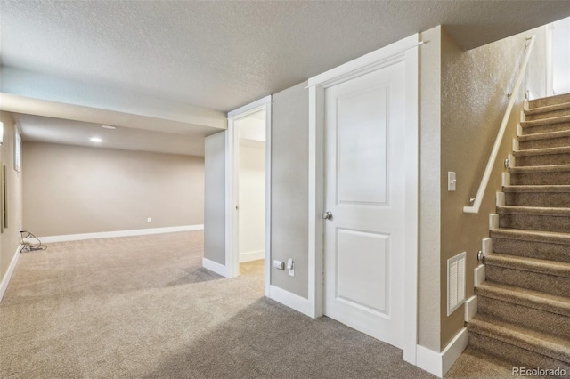 4293 Graham Ct, Boulder, CO 80305 - finished basement with carpet, a textured ceiling, stairs, and baseboards