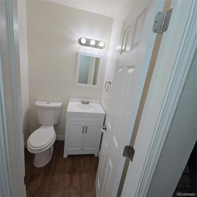 1512 12th Ave Unit 5, Greeley, CO 80631 - bathroom featuring vanity, wood finished floors, and toilet