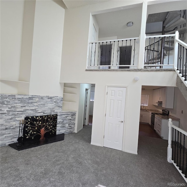 1512 12th Ave Unit 5, Greeley, CO 80631 - carpeted living area featuring a sink and a towering ceiling