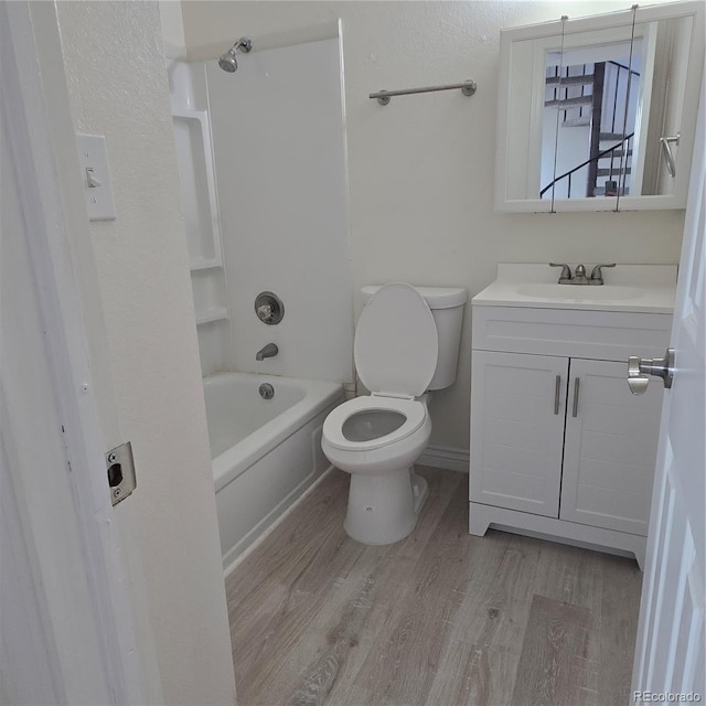 1512 12th Ave Unit 5, Greeley, CO 80631 - bathroom with toilet, vanity, wood finished floors, and bathtub / shower combination