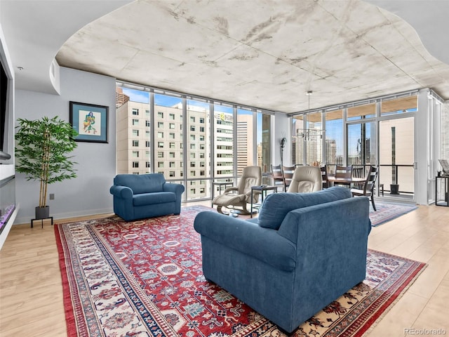 891 14th St Unit 1709, Denver, CO 80202 - living area featuring light wood-type flooring, plenty of natural light, and a wall of windows