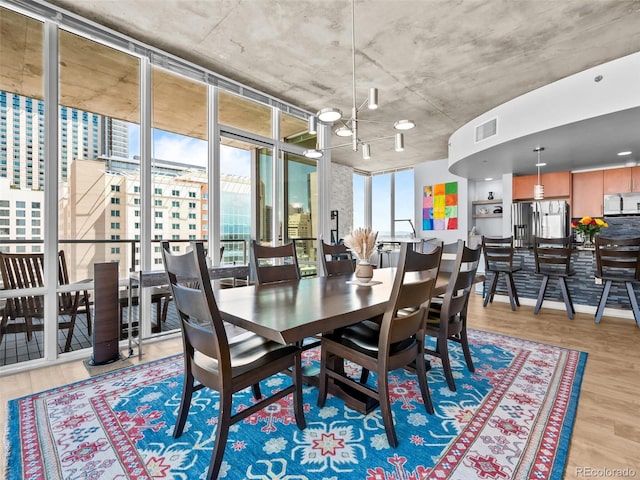 891 14th St Unit 1709, Denver, CO 80202 - dining space featuring light wood-type flooring and a chandelier
