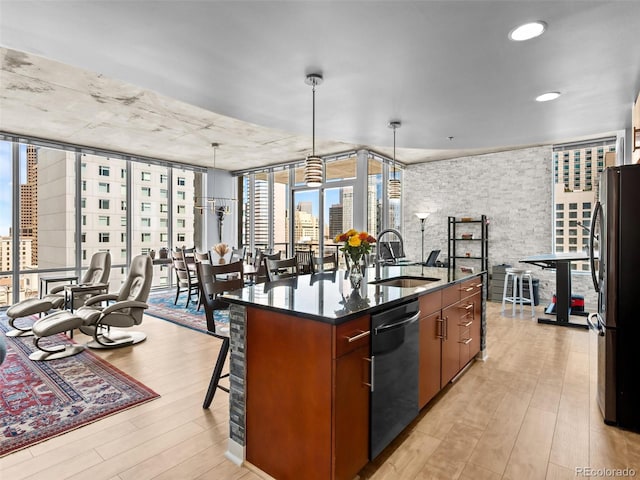 891 14th St Unit 1709, Denver, CO 80202 - kitchen featuring dishwasher, freestanding refrigerator, light wood-type flooring, an island with sink, and a breakfast bar