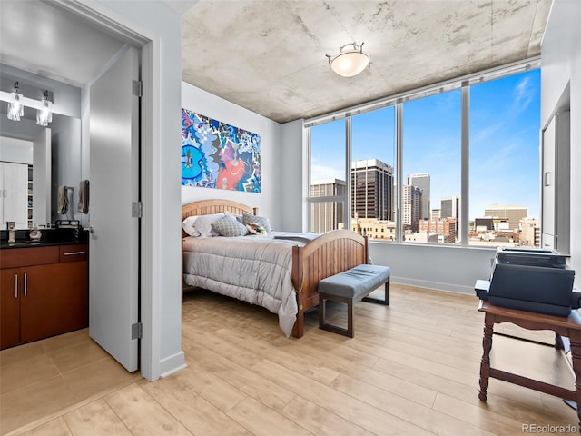 891 14th St Unit 1709, Denver, CO 80202 - bedroom with light wood-style flooring and a skyline view