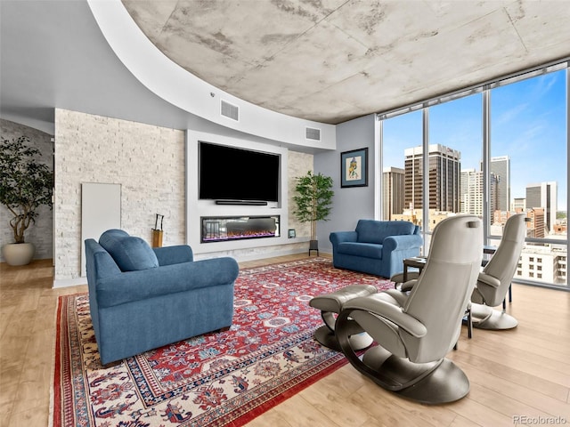 891 14th St Unit 1709, Denver, CO 80202 - living area with wood finished floors and a glass covered fireplace