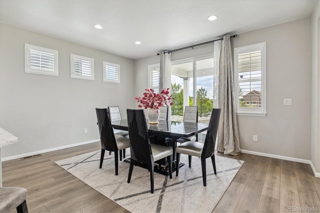 dining room with recessed lighting, wood finished floors, visible vents, and baseboards