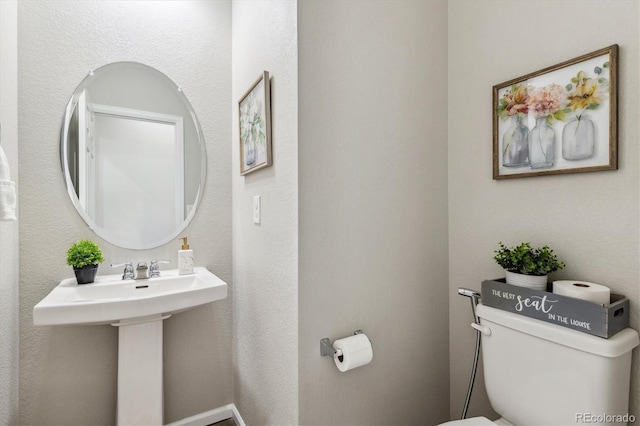 bathroom featuring toilet and a sink