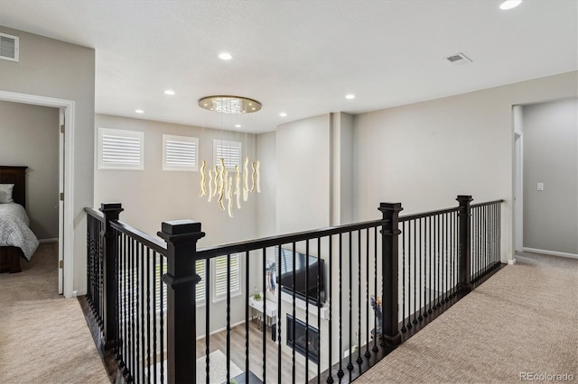 corridor with carpet flooring, an upstairs landing, recessed lighting, and baseboards