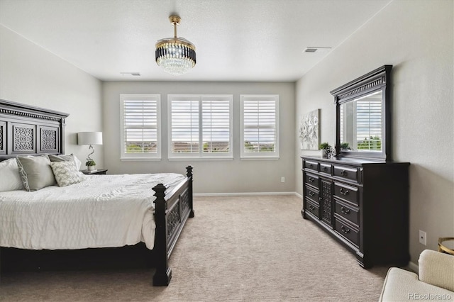 bedroom featuring light colored carpet, visible vents, and baseboards