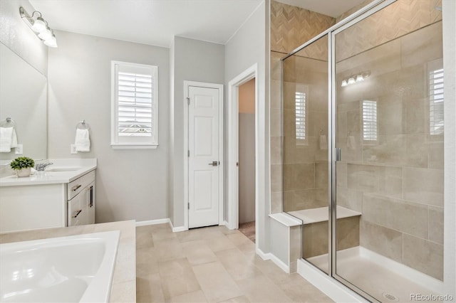 bathroom featuring vanity, baseboards, tile patterned flooring, a shower stall, and a bath