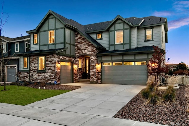 english style home featuring a garage, a shingled roof, driveway, and stucco siding