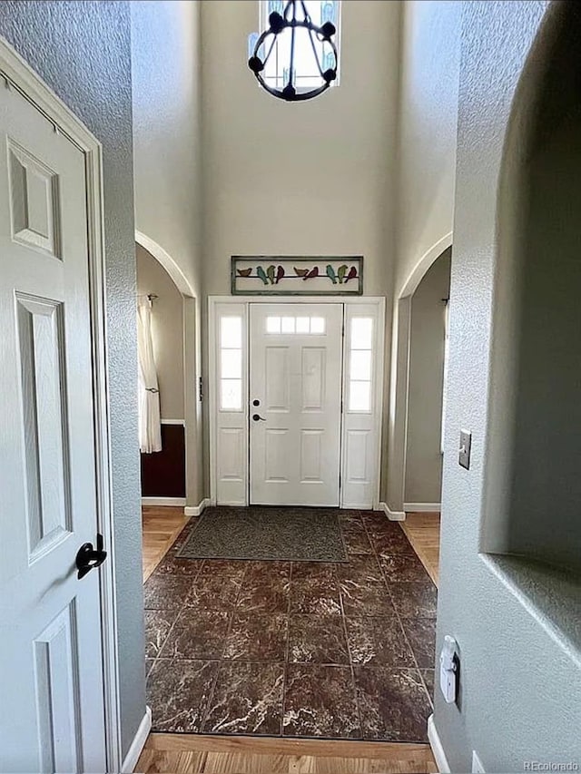 entrance foyer with hardwood / wood-style flooring and a chandelier