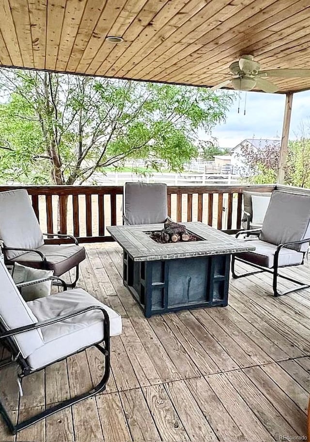 wooden deck featuring a fire pit and ceiling fan